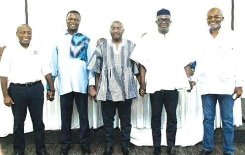 Five prominent members of the New Patriotic Party (NPP), including Dr. Mahamudu Bawumia and Kennedy Agyapong, are seen holding hands in a gesture of unity. They are standing in a row against a white backdrop, representing a show of solidarity within the party leadership.