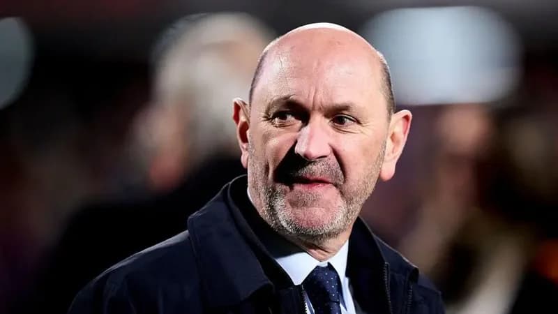 A close-up photograph of Pedro Rocha, who served as the interim president of the Royal Spanish Football Federation (RFEF). He is seen wearing a dark navy jacket over a light blue shirt and a patterned tie, looking thoughtfully toward the side against a blurred background.