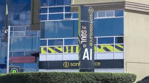 Getty Images The exterior of an office block with the Sama sign on it. A slogan says: "The soul of AI"