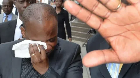 PA Media Pastor Eric Adusah leaves an inquest into the death in March 2015 of his wife Charmain Speirs in Ghana, where an open verdict was given by the Coroner in Chelmsford Essex.