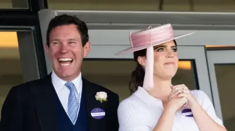 Samir Hussein/WireImage The couple both have big smiles and are dressed in formal clothing.
