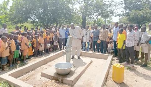 Dordoe Kudjoe Isaiah, Nkwanta North DCE, commissioning a hand pump at Kpassa D/A Basic School