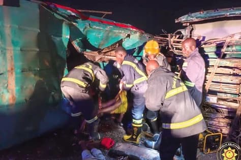 Personnel of the Ghana National Fire Service pulling out a victim from the wreckage