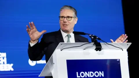 Getty Images Sir Keir Starmer talking at a lectern which says London in white writing against a blue background