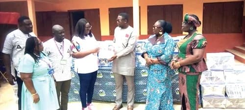 Rhoda Enyonam Arthur, VRA Community Relations Officer, presenting the VRA-branded exercise books to Godwin Bobobee, Asuogyaman District Chief Executive. With them is Augustina Adjoa Owusu (2nd from right), District Director of Education, Asuogyaman District