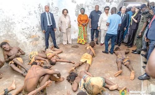 President John Dramani Mahama (4th from left), Mia Amor Mottley (5th from right), Prime Minister of Barbados, and other dignitaries watching the reenactment of slaves in a holding dungeon at the Osu Christiansborg Castle