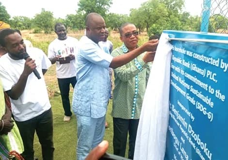 Dr Benjamin Dzoboku ( right), Managing Director of Republic Bank, being supported by Braimah Seidu (middle), District Chief Executive for Tolon, to unveil the borehole