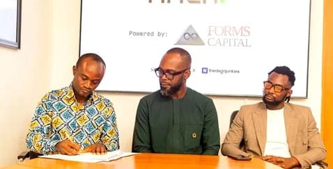 Ishmael Abbey (left), Head of Business Development, Forms Capital Limited, signing the partnership agreement. With him are Klenam Fiadzoe (middle), Co-founder, Socialite AF, and Samuel Allotey (right), Founder of The Design Junkies