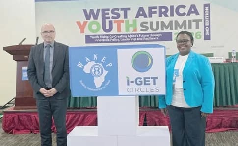 Jurgen Heissel (left), the Austrian Ambassador to Ghana, with Levinia Addae-Mensah, Executive Director of WANEP, displaying the IGET logo