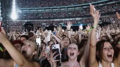 Live Nation/PA Several rows of predominantly female fans can be cheering, some holding their hands up, others holding their phones up in a shot of fans at Wembley Stadium for Harry Styles' performance last night. In the background, thousands of other people can be seen sat in the stands