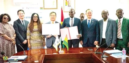 Donghyun Lee, KOICA Country Director and Haruna Iddrisu Education Minister (both with the signed document) after the signing. With them is Gyongsig Park (3rd from right), Korean Ambassador to Ghana and some management of the ministry and Koream Embassy