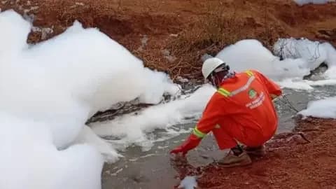 Nesrea Official in Nigeria collects sample from foamy substance on Abuja-Kaduna highway
