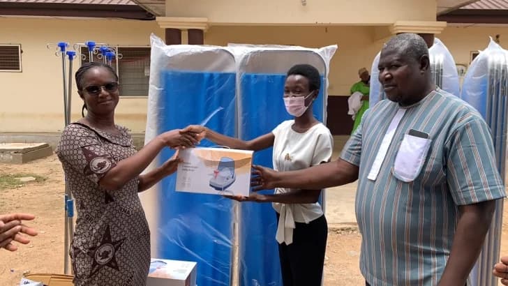 Dr Ama Antwiwaa Adu Appiah ( middle), Medical officer at the Paga Hospital, presenting the items to Zita Abdulaih (left), Nurse Manager at the Paga Hospital. Looking on is Raphael Pariyewe (right) , Organiser of the Paga Youth Movement