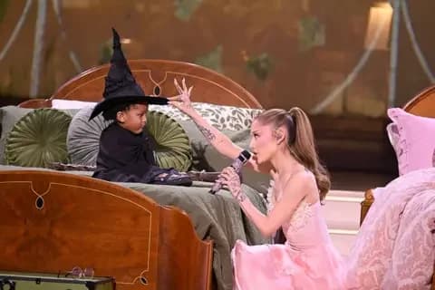 Getty Images Ariana Grande sings for a child wearing a witch's hat, during a live performance of music from the movie / musical Wicked