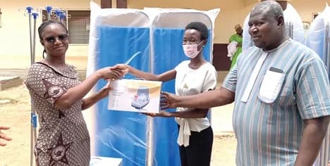 Dr Ama Antwiwaa Adu-Appiah (middle), Medical Officer at the Paga Hospital, presenting the items to Zita Abdulaih (left), Nurse Manager at the Paga Hospital. Looking on is Raphael Pariyewe (right), Organiser of the Paga Youth Movement