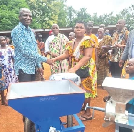 A person with disability receiving her livelihood support item from Daniel Dagba, Akatsi South MCE