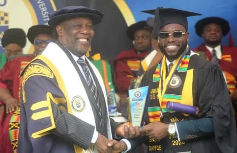 Divine D.K. Kpetigo (left), Council Chair of Ghana Communication Technology University, presenting the awards for the overall best postgraduate programme and best student in Business School to Bright Baffoe. Picture: ESTHER ADJORKOR ADJEI