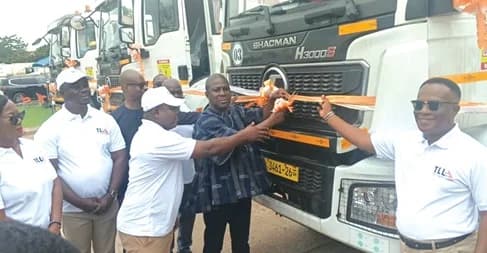 Kwesi Afreh Biney (in smock) Director-General of SSNIT, cutting a ribbon at the unveiling of new haulage fleet for the Trust Logistics Limited at Tema. With him is Maxwell Ziyerley Agbambilla (3rd from right), Managing Director, Trust Logistics Limited, and Felix Nyarko-Pong ( right), Board Chairman, Trust Logistics Limited