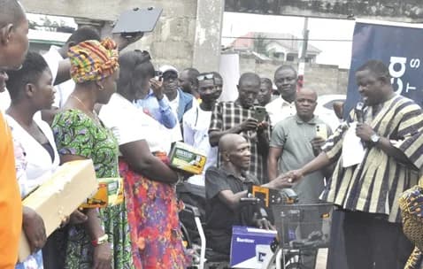 Togbe Anikpi III (2nd from left), Dufia of Ho-Heve, being assisted by Stephanie Oforiwah Asare (left),the Corporate Social Responsibility Coordinator of OneAfrica Markets, and Dr Doh to cut the tape to commission the borehole