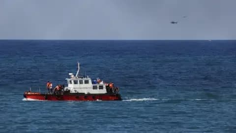 Reuters People in orange life jackets stand on a red and white rescue vessel, after a boat capsized off the coast of Kyrenia, in the Turkish-controlled northern Cyprus.