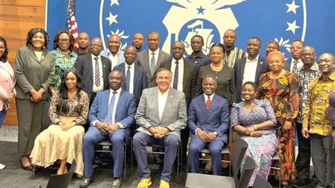 Kwabena Mintah Akandoh (seated 2nd from right), Minister of Health, with Andrew J. Ginther (middle), Columbus Mayor, and other dignitaries after the signing ceremony