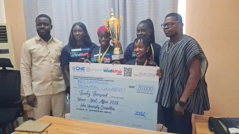 A group of six individuals from Bolgatanga Technical University celebrate their victory at the WinE Affair 2026 Inter-University Competition. They are seen holding a golden trophy and a large ceremonial check for 20,000 Ghana Cedis awarded by Women in Engineering (WinE).