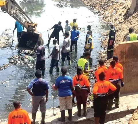 Some volunteers and staff of the Ashaiman Municipal Assembly desilting the drain during the last National Sanitation Day exercise