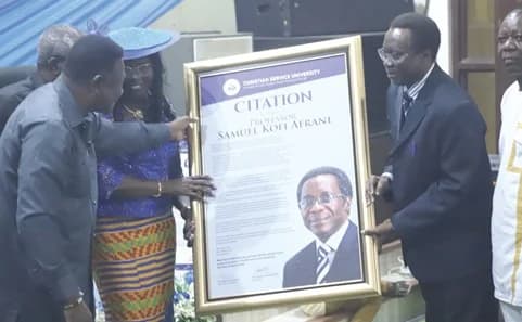 Most Rev. Prof. Emmanuel K. Asante (left), Chancellor, CSU, presenting a citation to Prof. Samuel Kofi Afrane (right), immediate past Vice-Chancellor, CSU, during his send off service in Kumasi. Also in the picture is Augustina Afrane (2nd from left), wife of Prof. Afrane. Picture: EMMANUEL BAAH