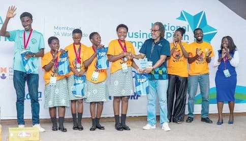 Contestants of Adonten SHS receiving their award from Edem Amedi-Addie (4th from right), Executive Director of JA Ghana
