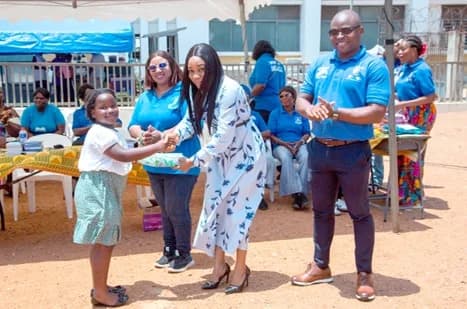 Evelyn Anyenini, a legal practitioner, presenting an award to a pupil. Looking on are Reginald Dzonu-Ahlijah, Grand Knight of Council 71, and Veronica Zigah, Noble Lady of Court 63, Dansoman in Accra