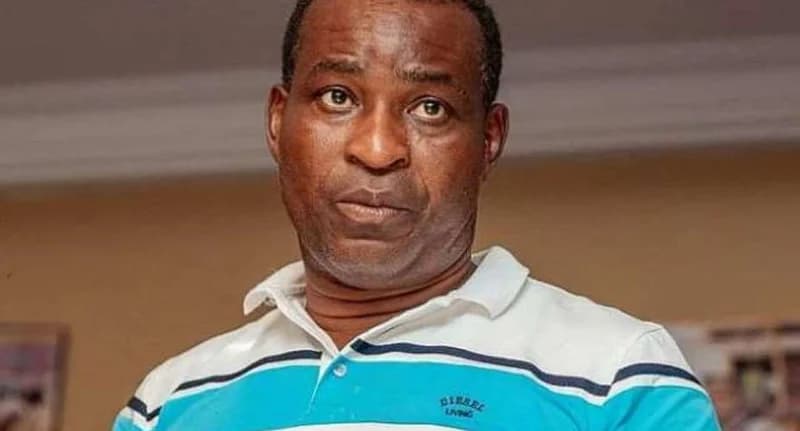 A close-up portrait of Bernard Antwi Boasiako, popularly known as Chairman Wontumi, the Ashanti Regional Chairman of the New Patriotic Party (NPP). He is wearing a white polo shirt with blue and black stripes and has a serious expression.
