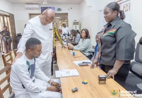 Samuel Okudzeto Ablakwa (2nd from left), Minister of Foreign Affairs, interacting with an applicant (seated) while a female staff of the Ashanti Regional Passport Application Centre looks on