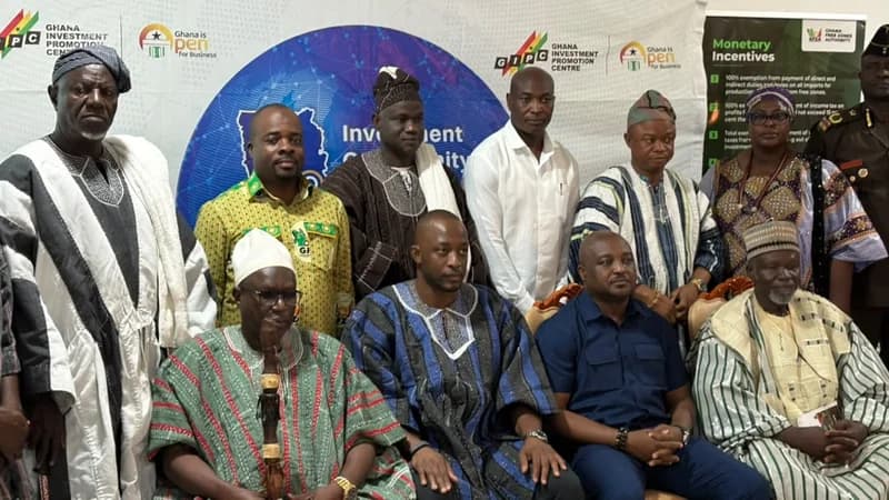 A group of Ghanaian traditional rulers and government officials pose for a photograph at an investment promotion event. The participants are standing and seated in front of a backdrop featuring the Ghana Investment Promotion Centre (GIPC) logo and information about monetary incentives from the Ghana Free Zones Authority.